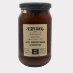 Rich, amber-colored Apple Barberry Spread in a glass jar, showcasing the vibrant blend of Himalayan apples and blue barberries
