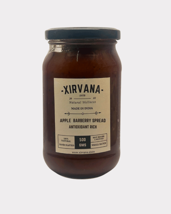 Rich, amber-colored Apple Barberry Spread in a glass jar, showcasing the vibrant blend of Himalayan apples and blue barberries