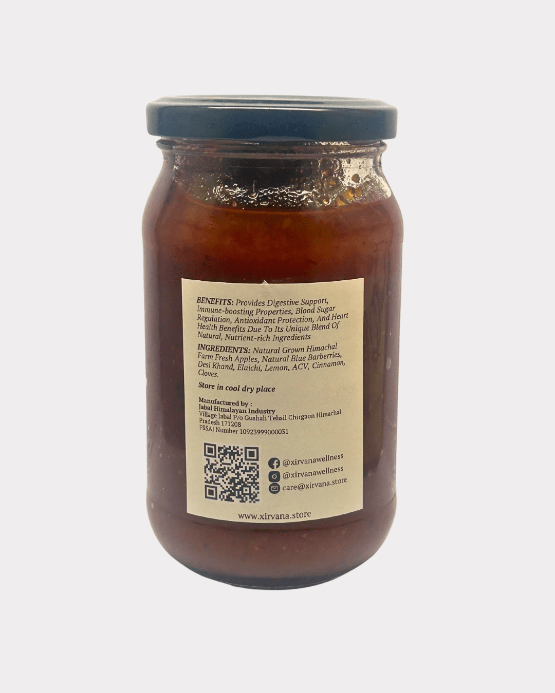 Rich, amber-colored Apple Barberry Spread in a glass jar, showcasing the vibrant blend of Himalayan apples and blue barberries